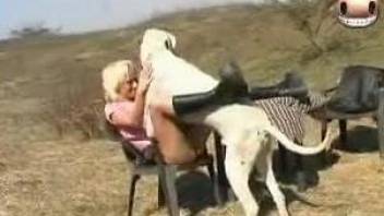 Blonde babe moans of pleasure with the dog fucking her