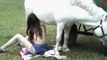 Redheaded beauty enjoying the taste of horse cock