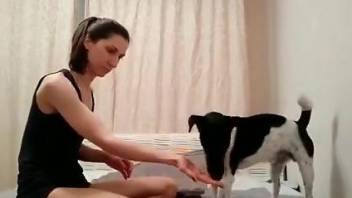 Brunette dressed in black is getting fucked by a dog