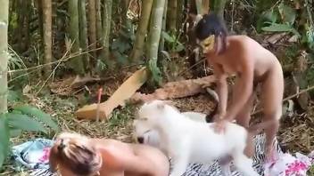 Tanned babes share dog dick in outdoor nature XXX