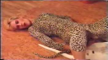 Leopard print hottie fucks a dog